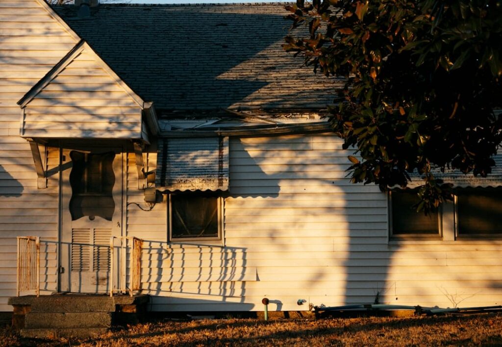 A house exterior decorated tastefully for the holidays, with snow