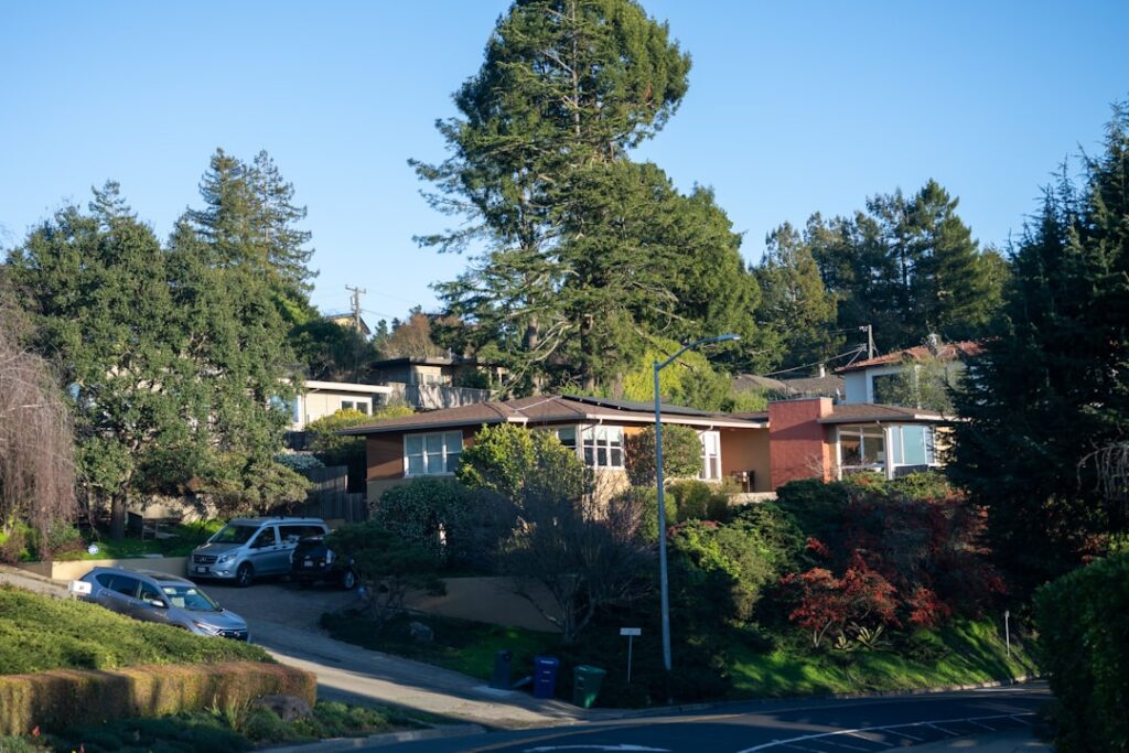 Beautiful, modern suburban home in a sunny, upscale neighborhood with rolling hills in the background, representing a valu...