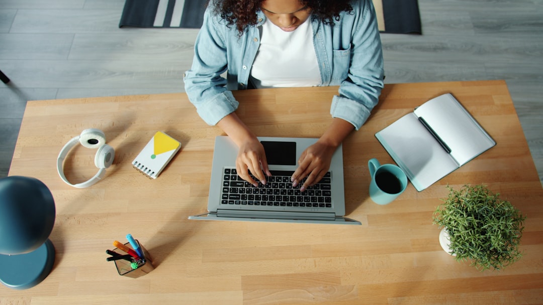 A real estate professional in a bright, modern home office, focused on a laptop, symbolizing a data-driven approach to property valuation.