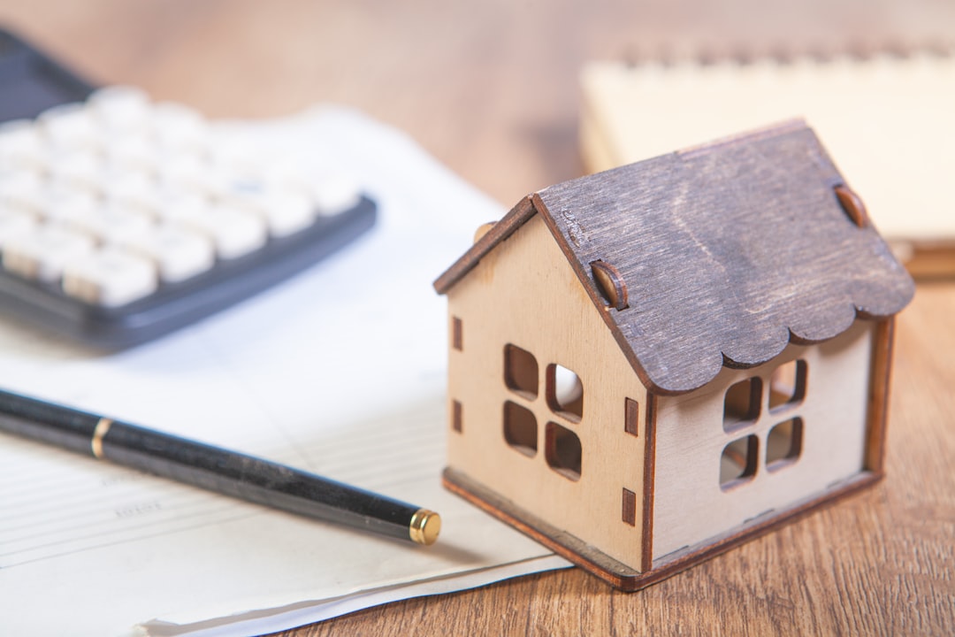 A close-up shot of house keys and a calculator resting on a professional wooden desk, symbolizing the smart financial calculations involved in a rate buydown.