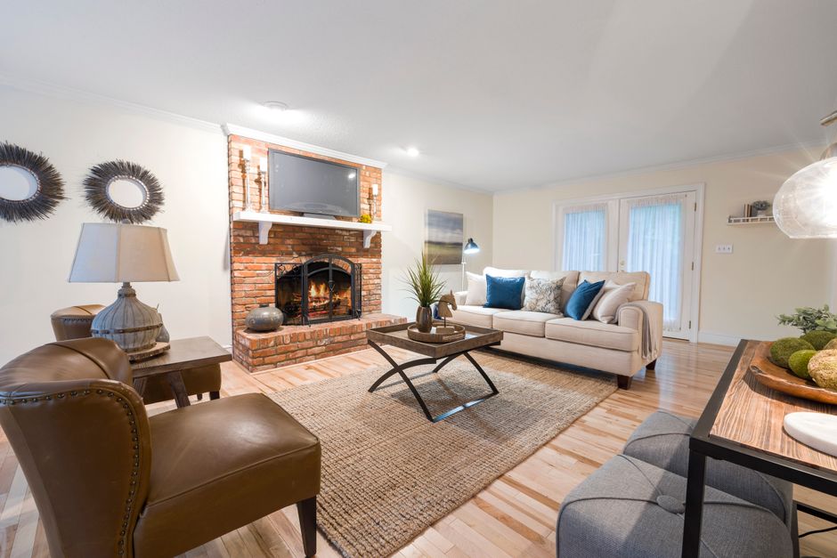 The interior of a bright, professionally staged modern living room, representing a high-value home that is ready for a quick sale.