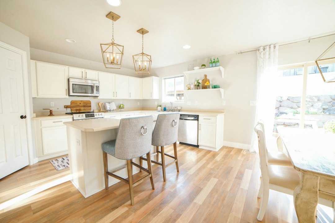 A professionally photographed, bright and modern kitchen in a beautiful home, showcasing the high-quality marketing included in a full-service real estate listing.