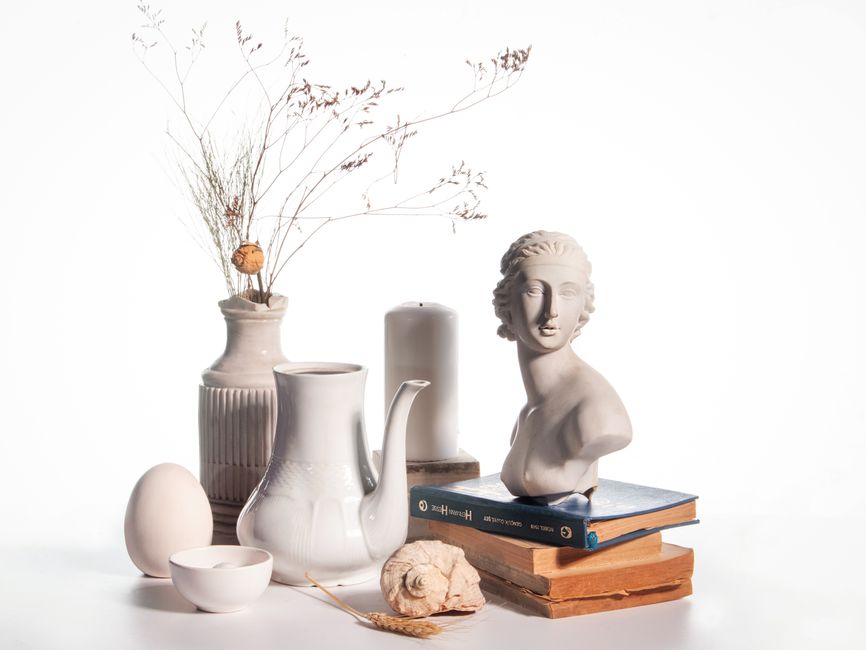 A sleek, white ceramic piggy bank sitting on a desk in a bright, modern home office, symbolizing smart savings and maximizing home equity.